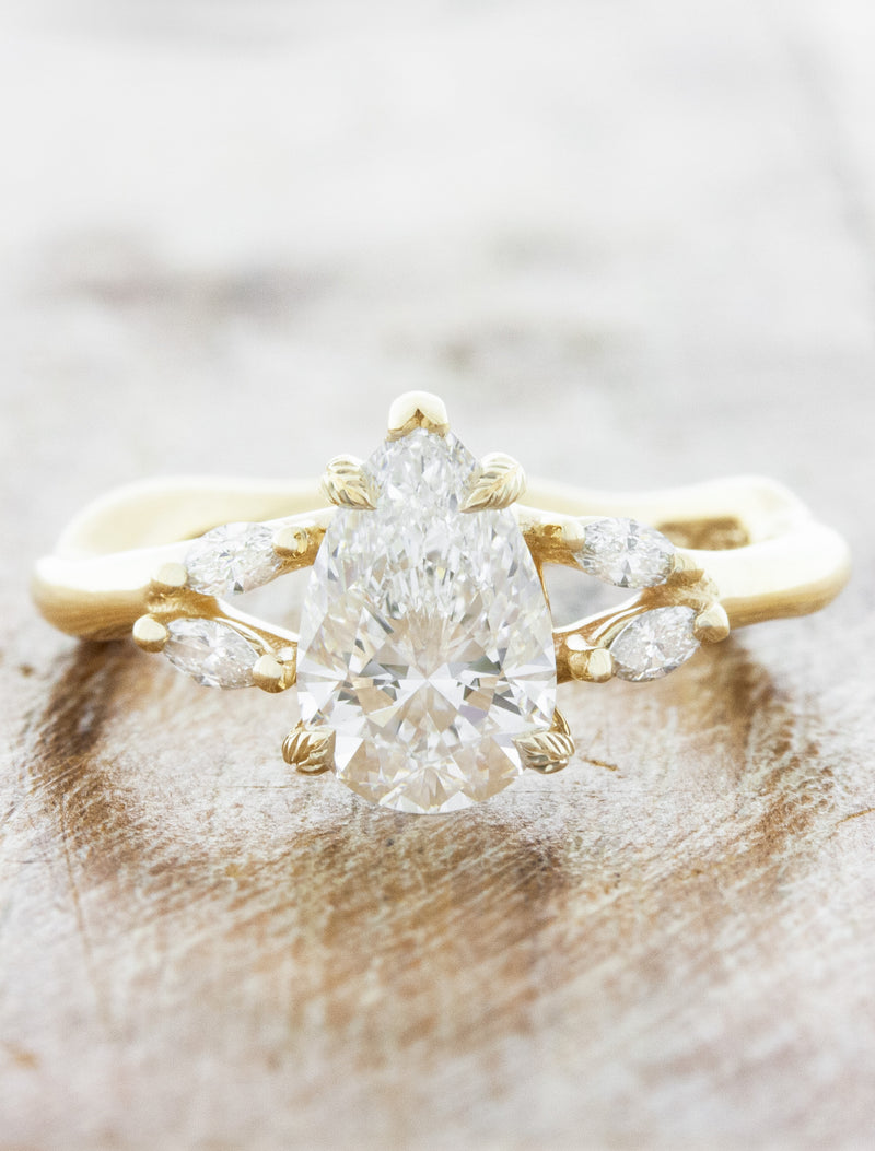 caption:Shown with 1ct pear diamond in 14k yellow gold