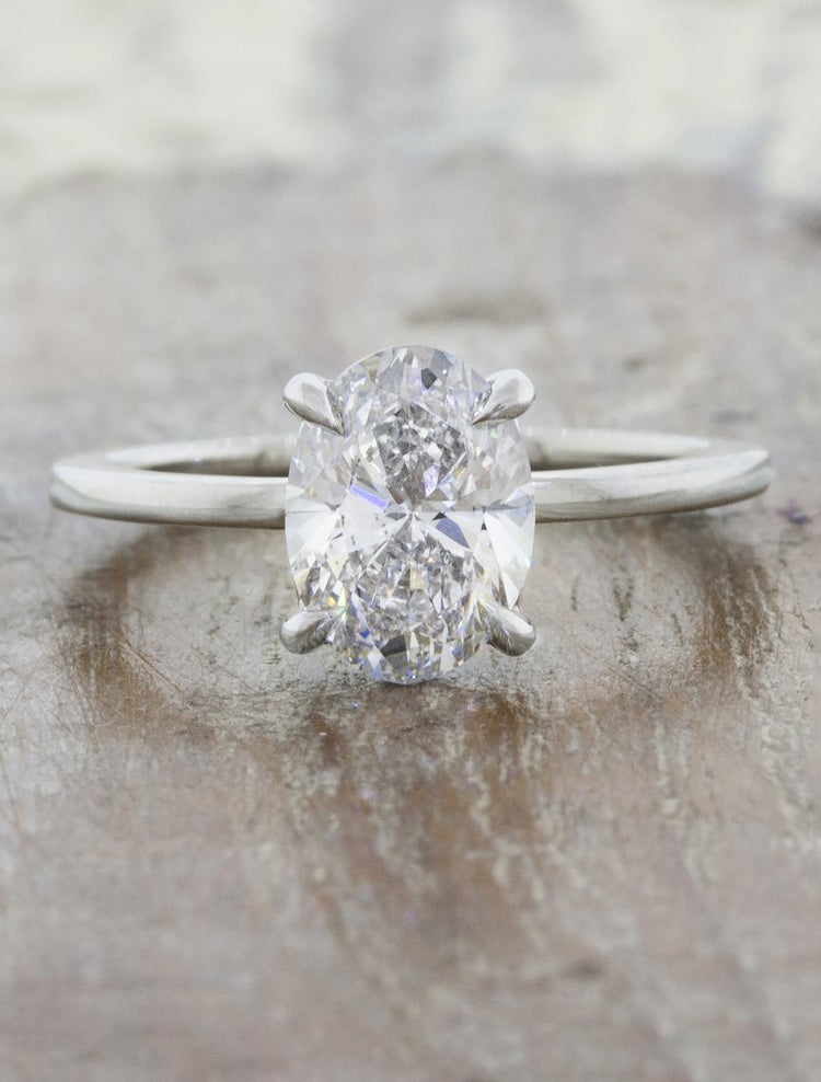 caption:Shown with a 1.51ct oval diamond in platinum